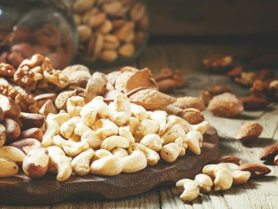 Raw cashew nut in the set, vintage wooden background, selective focus